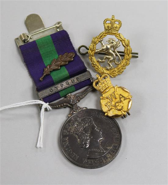 A Queen Elizabeth general service medal with Cyprus bar to Sergeant M. J. Hall of W.R.A.C and two related cap badges (3)